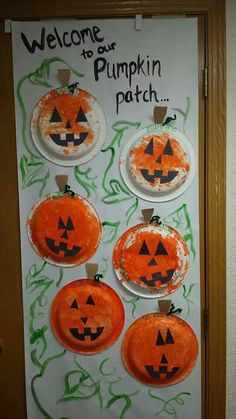 paper plates with pumpkin faces on them are hanging from a door frame that says, welcome to our pumpkin patch