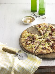 a pizza sitting on top of a wooden cutting board