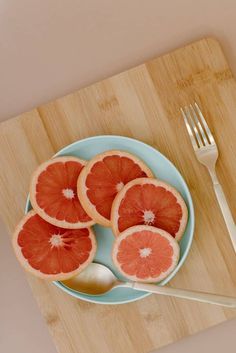 slices of grapefruit on a plate with a fork