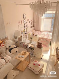 a living room filled with lots of furniture next to a bed and desk in front of a window