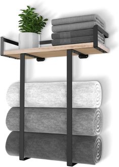 a shelf with towels and a potted plant on it