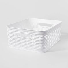 a white plastic basket on a grey background