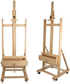 two wooden easels sitting side by side on wheels