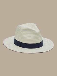 A classic wide-brim fedora, in a sturdy, lightweight paper straw, with grosgrain band detail.  Adjustable drawstring inside the band creates a perfect, custom fit.  Interior circumference: Small 22", Medium 23", Large 24" Brim: 2. 75" Classic Solid Color Sun Hat For Beach, Casual Paper Straw Boater Hat, Classic Beach Sun Hat, Solid Color Straw Panama Hat With Curved Brim, Casual Paper Straw Fedora With Short Brim, Classic Wide Brim Fedora With Upf 50+, Classic Spring Fedora With Curved Brim, Spring Classic Fedora With Curved Brim, Classic Solid Color Boater Hat For Spring