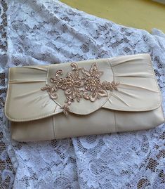 "Beautiful purse for special occasion, Wedding or Church ceremony, BRIDESMAIDS, Mother of the bride or of the Groom. The lace applique is cotton with hand sewn beads, pearls, and sequins as shown in the picture. COLORS:  PINK CHAMPAGNE/ROSE GOLD (AS PICTURED) CHAMPAGNE/ROSE GOLD IVORY/ROSE GOLD WHITE ROSE GOLD Dimentions: 11\" x 5.5\" Shoulder strap cord, may be hidden when not in use. NO RETURNS, NO EXCHANGES, FINAL SALE! PEASE CONTACT FOR ANY ADDITIONAL QUESTIONS." Elegant Embroidered Wedding Bridal Accessories, Elegant Embroidered Bridal Accessories For Wedding, Elegant Embroidered Cream Evening Bag, Elegant Cream Embroidered Evening Bag, Elegant Embellished Lace Bridal Accessories, Champagne Evening Bag For Wedding, Elegant Embroidered Evening Bag For Wedding, Elegant Embellished Evening Bag For Wedding, Elegant Embroidered Bag For Wedding