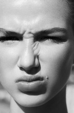 a woman's face with her eyes closed and the nose partially covered in wrinkles