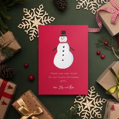 a christmas card with a snowman on it surrounded by presents and pineconis