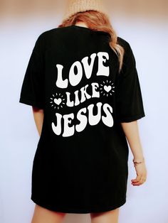 Spread a Message of Faith with this cute Love Like Jesus Shirt! This Christian Comfort Colors® Tshirt is super comfy! Size up for a Trendy Oversized Look! SHIPS FREE! SIZING TIPS: Size up 2-3 sizes from your "usual size" to get the "Oversized" Look! (2 sizes up is most common, and 3 sizes up is more dramatic) For a "relaxed fit" order your "usual size". When in doubt, lay your favorite fitting Tee flat and measure armpit to armpit and compare the width against the Size Chart in the photos. PROCE Love Like Jesus Shirt, T Shirt Text Design, Christian Comfort, Couple T Shirt Design, Message T Shirts, Black Tees, Love Like Jesus, Love Store, Comfort Colors Tshirt