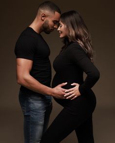 a pregnant couple standing next to each other