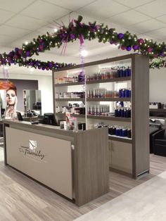 the inside of a hair salon with purple and green decorations