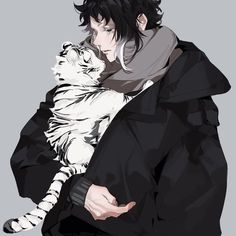 a man holding a white tiger in his arms while wearing a black coat and scarf