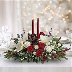 a centerpiece with red candles and white flowers