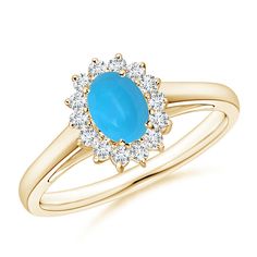 a yellow gold ring with an oval blue stone surrounded by small white diamond halos