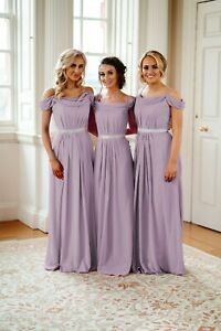 three bridesmaids in purple dresses posing for the camera