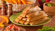 there are many different types of food on the table, including tortillas and peppers