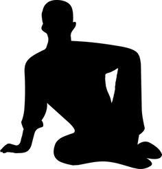 a man sitting on the ground with his legs crossed in front of him, silhouetted against