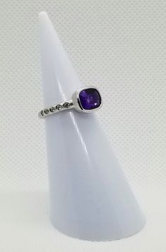 14k solid white gold hammered ring with 0.15 ct. SI1, G color natural brilliant diamonds & 1.60 ct. 9x7 mm cushion natural amethyst. This item can also be ordered in rose or yellow gold with different color gem stones such as blue topaz, London blue topaz, green amethyst, pink amethyst, citrine, smoky quartz, white topaz, garnet, peridot, morganite & aquamarine. Please contact for a quote as each gemstone varies in price. I am a manufacturer of fine jewelry for over thirty years, custome Modern Amethyst Diamond Ring As Gift, Modern Amethyst Ring With Diamond For Gift, Modern Diamond Amethyst Ring, Modern Amethyst Diamond Ring, Hammered Ring, Hammered Rings, Colored Gems, Pink Amethyst, Gem Stones