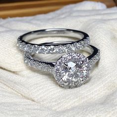 two wedding rings sitting on top of a blanket