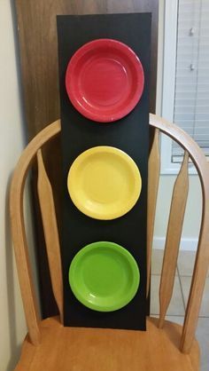 three plates are stacked on top of each other in front of a black and yellow chair