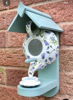 a blue bird house with a flowered design on it