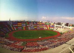 an aerial view of a baseball stadium with many fans in it and the field is full of flags