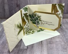 the inside of an open greeting card with green leaves and pineconi on it