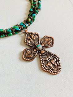 "Beaded Turquoise and Copper Cross Pendant Necklace, Turquoise Choker, Boho Statement Jewelry, Handmade Gifts for Her This triple Stranded Turquoise Beaded Statement Choker is adorned with a 3\" gorgeous copper cross! Choker Necklace is adjustable up to 17\" maximum.  Please check out the rest of my items here. I gladly combine postage. https://www.etsy.com/shop/ItsaGThingBoutique" Artisan Turquoise Beaded Jewelry, Spiritual Beaded Turquoise Jewelry, Spiritual Turquoise Beaded Jewelry, Bohemian Turquoise Copper Jewelry, Southwestern Style Green Beaded Necklace For Gift, Green Southwestern Beaded Necklace Gift, Southwestern Style Green Beaded Necklace Gift, Green Southwestern Style Beaded Necklace For Gift, Green Southwestern Style Beaded Necklace As Gift