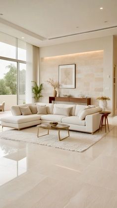 a living room filled with white furniture and large windows overlooking the cityscape in the distance