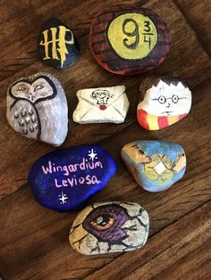 painted rocks with writing on them sitting on a table