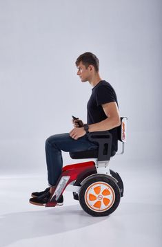 a man sitting in a small tricycle using his cell phone