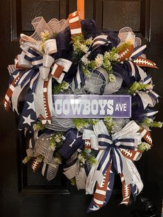 a wreath with the words cowboys avenue on it and american flags hanging from it's sides