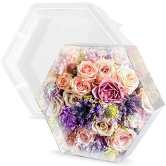 a large bouquet of flowers in a clear box on a white background with the lid open