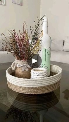 a glass table topped with a bottle and flowers