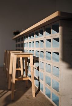 two stools sitting next to each other near a wall