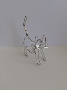 a metal cat sculpture sitting on top of a table