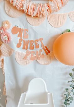 an orange balloon and some paper plates on a table