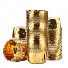 several gold colored cups are stacked on top of each other