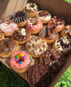 a box filled with lots of different flavored donuts