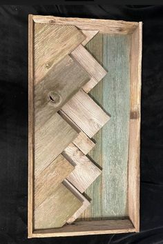 a wooden frame with some wood pieces cut out in the shape of an arrow on it