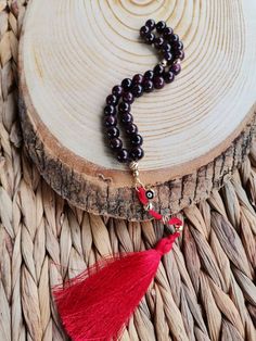 ✔️ 8 mm round cut garnet stone beads with Red tassel and Evil Eye charm ✔️ Natural Color Women tesbih ✔️ High Grade Natural Garnet Stone Tasbih ✔️ This glamorous tasbih is a very special gift for your loved ones. ✔️ Each order comes in a special box. ✔️ PLEASE CLICK THE LINK FOR ALL PRAYER BEADS MODELS https://www.etsy.com/shop/GoodJewelsofYazmasal Note: As a natural feature the stones beads may have some variations. SHIPPING: United States (Standart/DHL eCommerce/usps): 7-10 business days Unite Red 8mm Beads Spiritual Mala, Red Handmade Mala For Healing, Spiritual Red Beads, Gems, And Cabochons For Gifts, Adjustable Red Mala For Gift, Adjustable Red Mala As Gift, Adjustable Red Mala As A Gift, Red Hand-strung Mala For Healing, Bohemian Red Mala For Gift, Spiritual Red Carnelian Beads