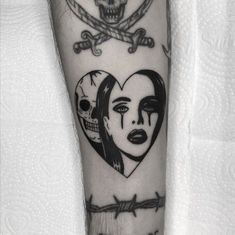 a woman's arm with a skull and heart tattoo on it