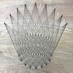 an intricately designed piece of wood on top of a wooden surface with lines drawn across it