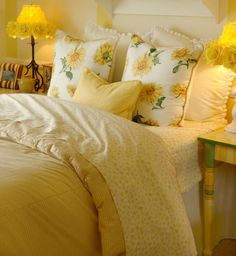 a bed with yellow flowers on the pillows