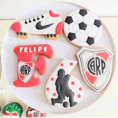 decorated cookies are arranged on a plate with the letters e, f, and football