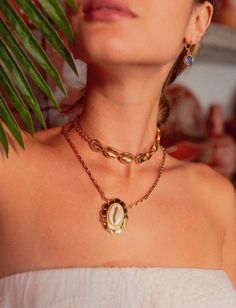 "There are 2 necklaces in this listing! Introducing our captivating choker, meticulously crafted with interconnecting golden shells adorning its 15\"/36cm length. With an elegant anatomical lobster clasp and a 3\"/10cm lengthening chain at the tip, this choker is as comfortable as it is stylish. Finished with luxurious gold plating, it's sure to make a statement wherever you go! We also have our delightful chain necklace adorned with a stunning cowrie shell medallion! Fastened with an anatomical clasp, it's not just stylish, it's a breeze to wear. With a perfect length of 17\"/42cm and a charming 3\"/10cm lengthening chain, all bathed in radiant gold plating, this necklace is sure to bring sunshine to your day! Welcome to Avinzia! Discover beautifully crafted jewelry designed to exceed you Gold Ocean-inspired Charm Necklaces As Gift, Gold Ocean-inspired Charm Necklace For Gift, Ocean-inspired Gold Charm Necklace For Gift, Gold Ocean-inspired Pendant Jewelry, Ocean-inspired Gold Pendant Jewelry, Handmade Gold Plated Chain Necklace, Gold Jewelry With Lobster Clasp As Gift For Her, Handmade 14k Gold-filled Necklaces, Handmade Gold Plated Choker Jewelry