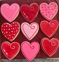 decorated cookies in the shape of hearts on a table