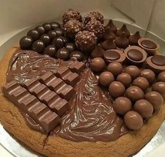 there is a cake with chocolate and candy on it