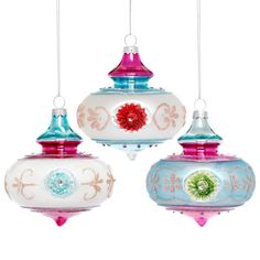 three colorful glass ornaments hanging from strings