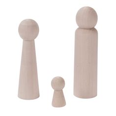 two wooden pegs and one is standing next to each other on a white background