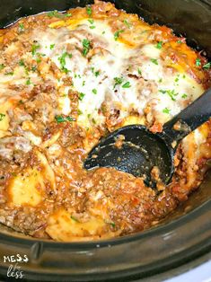 a crock pot filled with lasagna casserole, cheese and meat